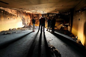 St Saviour's GAA Club members pictured inside their burned-out clubhouse on Saturday morning after an overnight fire at both the club and the local Youth Resource Centre (inset) left the community in a state of shock.| Photos: Noel Ryan 