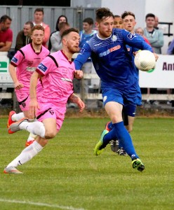 Shane Dineen stops Wexford Youths striker Danny Furlong at Ferrycarrig.