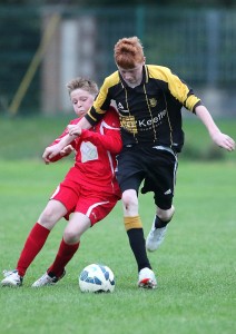 Park Rangers' Matthew Doherty and Johnville’s Craig Kavanagh jostle for possession. 