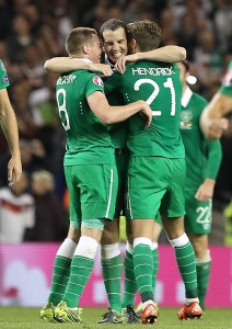 Irish skipper John O'Shea embraces James McCarthy and Jeff Hendrick following last Thursday's victory over Germany in Dublin. See Sport 23 and 24 for more. 