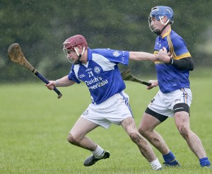 Tramore’s Conor Lynch struggles to break clear from Portlaw’s Jack Walsh. 