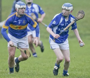 Tramore’s Jack O’Byrne about to clear, with Portlaw’s Jake Scanlon in pursuit. 