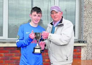 Mount Sion captain Justin Croke receives the Munster U-17 SFAI Schools Cup from Matt Keane.