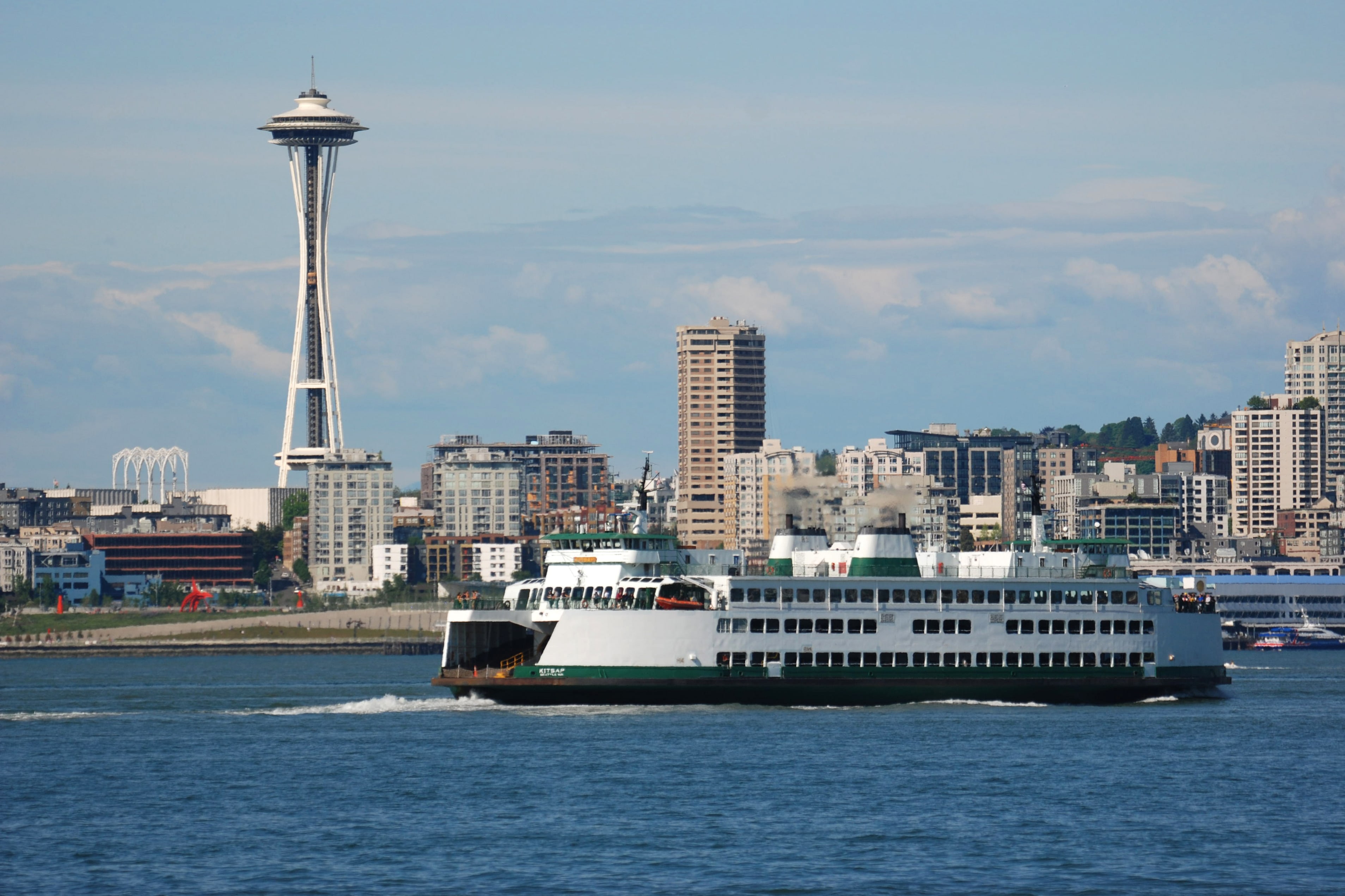 A Washington State Ferry makes its way across Elliot Bay under the watchful eye of the Space Needle.