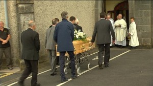 The remains of the late Austin Deasy are received at Saint Mary's Church in Dungarvan.  									| Still: RTE 