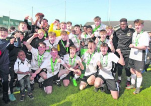 Tramore players and mentors celebrate their victory over St. Kevin's Boys in the FAI Junior Cup