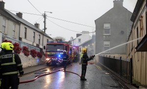 Firefighters tackling the aftermath of last Saturday's blaze.	 | Photo: Jim O'Sullivan 