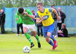 Waterford FC’s John Martin takes on Irish Universities Joe Manley.
