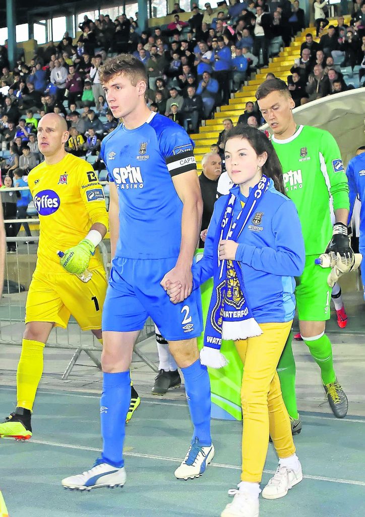 Waterford FC captain Rory Feely leads his team out with mascot, Alexia Kavanagh-Foran.