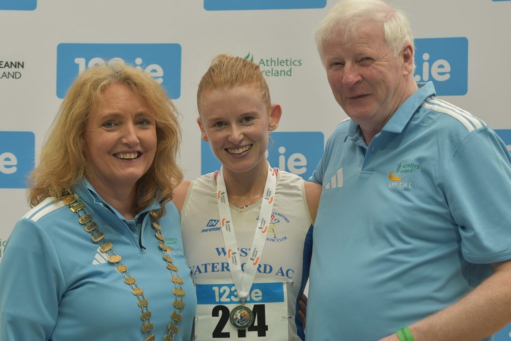 Kate Veale who claimed gold at the 123.ie National Senior Indoor Championships, pictured with Bríd Golden, Ferrybank, and John McGrath, West Waterford Athletic Club.