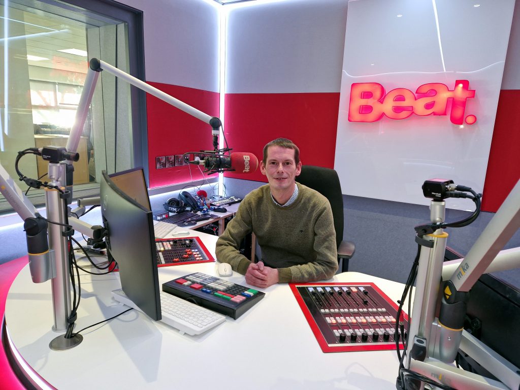 Niall Power behind at the desk at Beat 102 103. Photo: Pól Ó Maonaigh