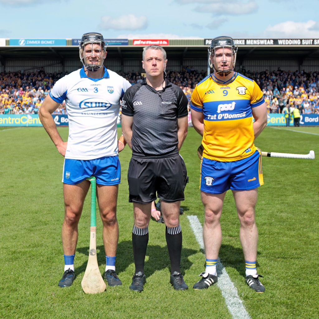 Team captains Mark Fitzgerald (Waterford) & Tony Kelly (Clare) with referee Shane Hynes (Galway).